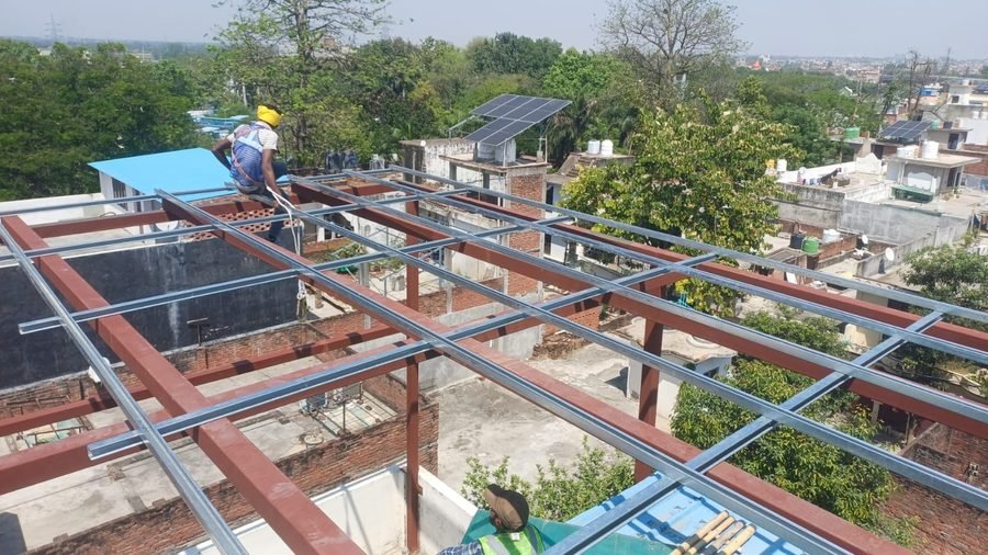 Site team installing solar modules on mounting structures